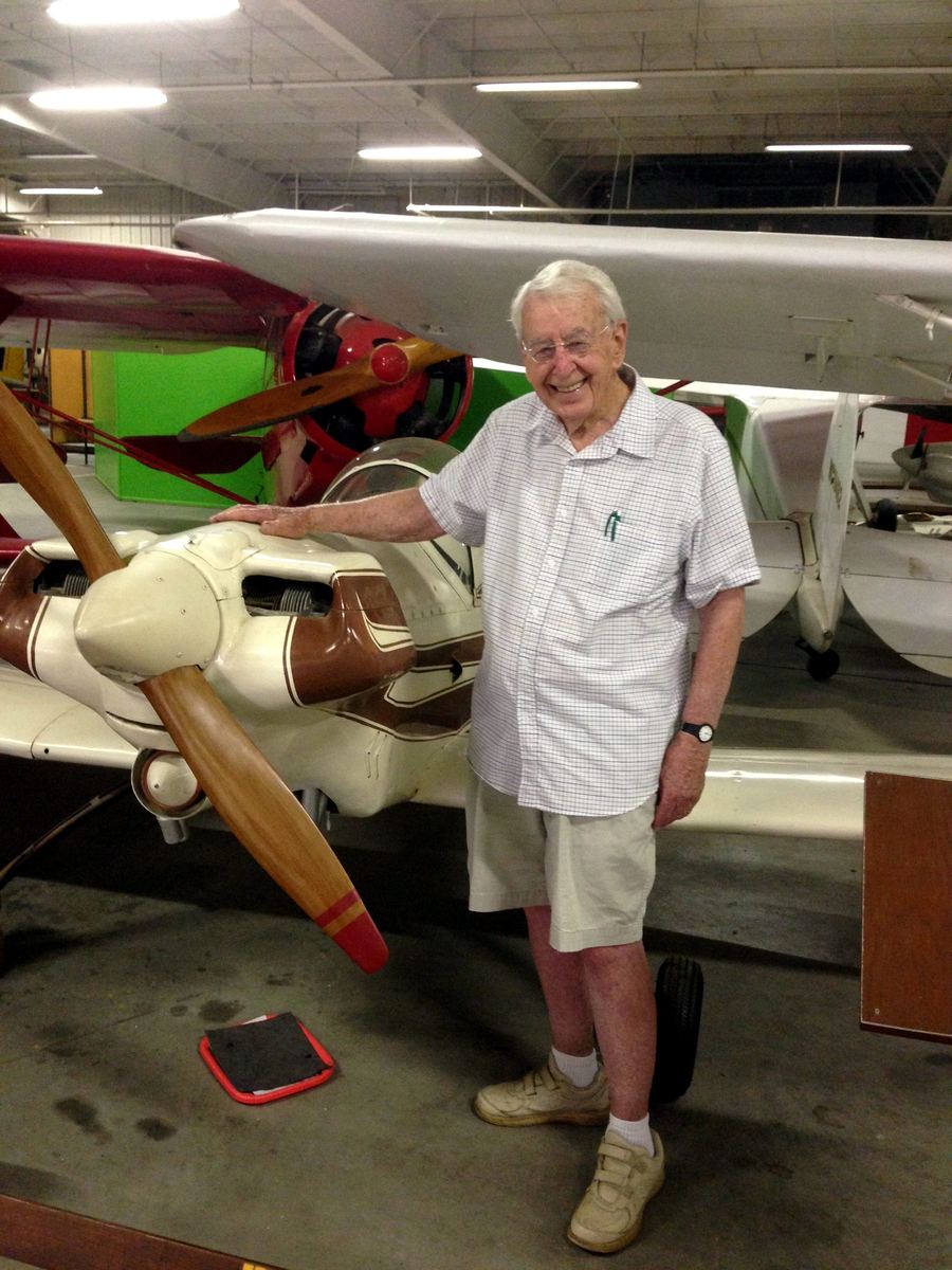 A Liberal man with the plane he designed, built, and gave to the museum.